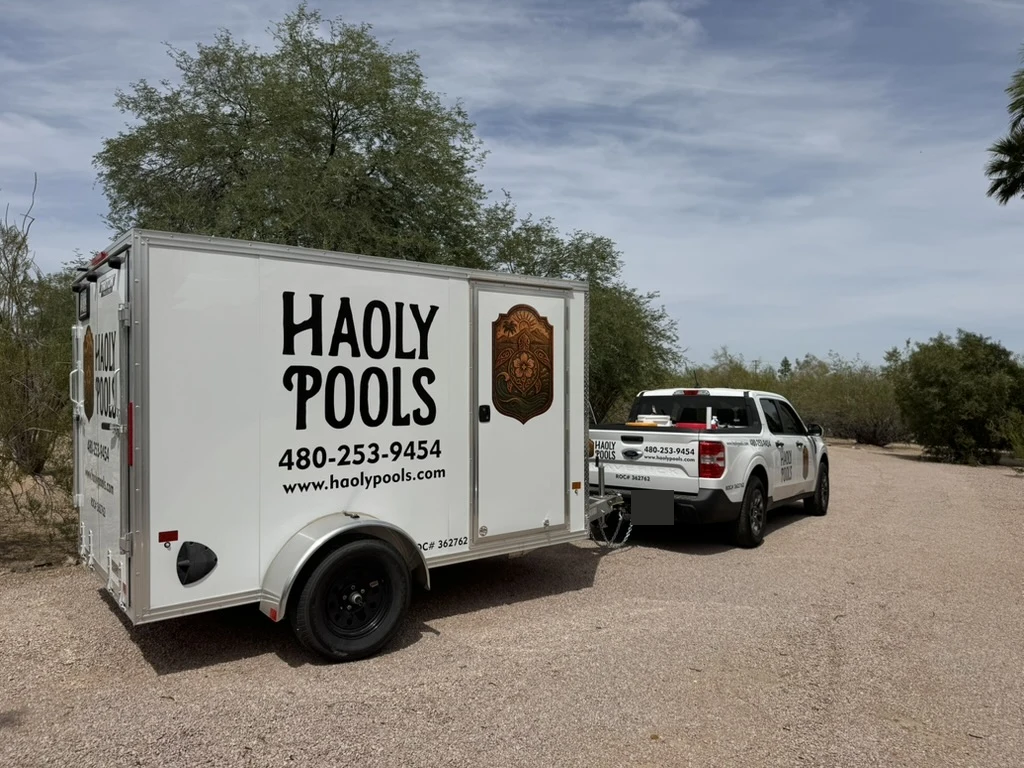 Haoly Pools truck and trailer on a desert driveway